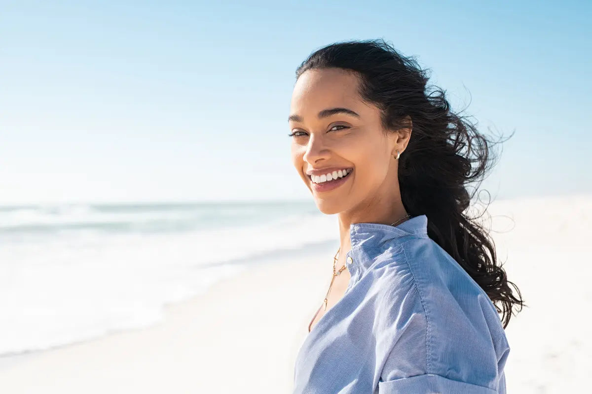 woman my the beach smiling