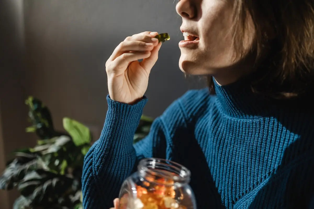 woman taking adult multivitamin gummies and showing it is generally safe