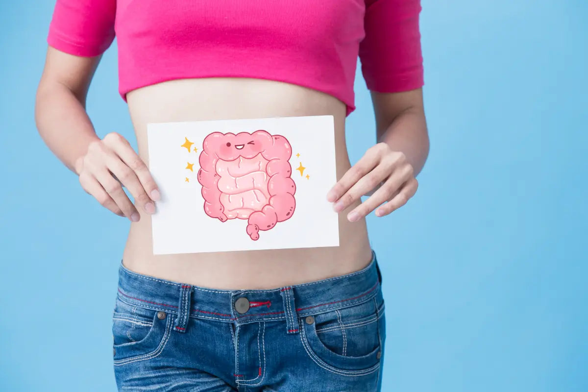 woman holding a drawing of an animated and smiling colon