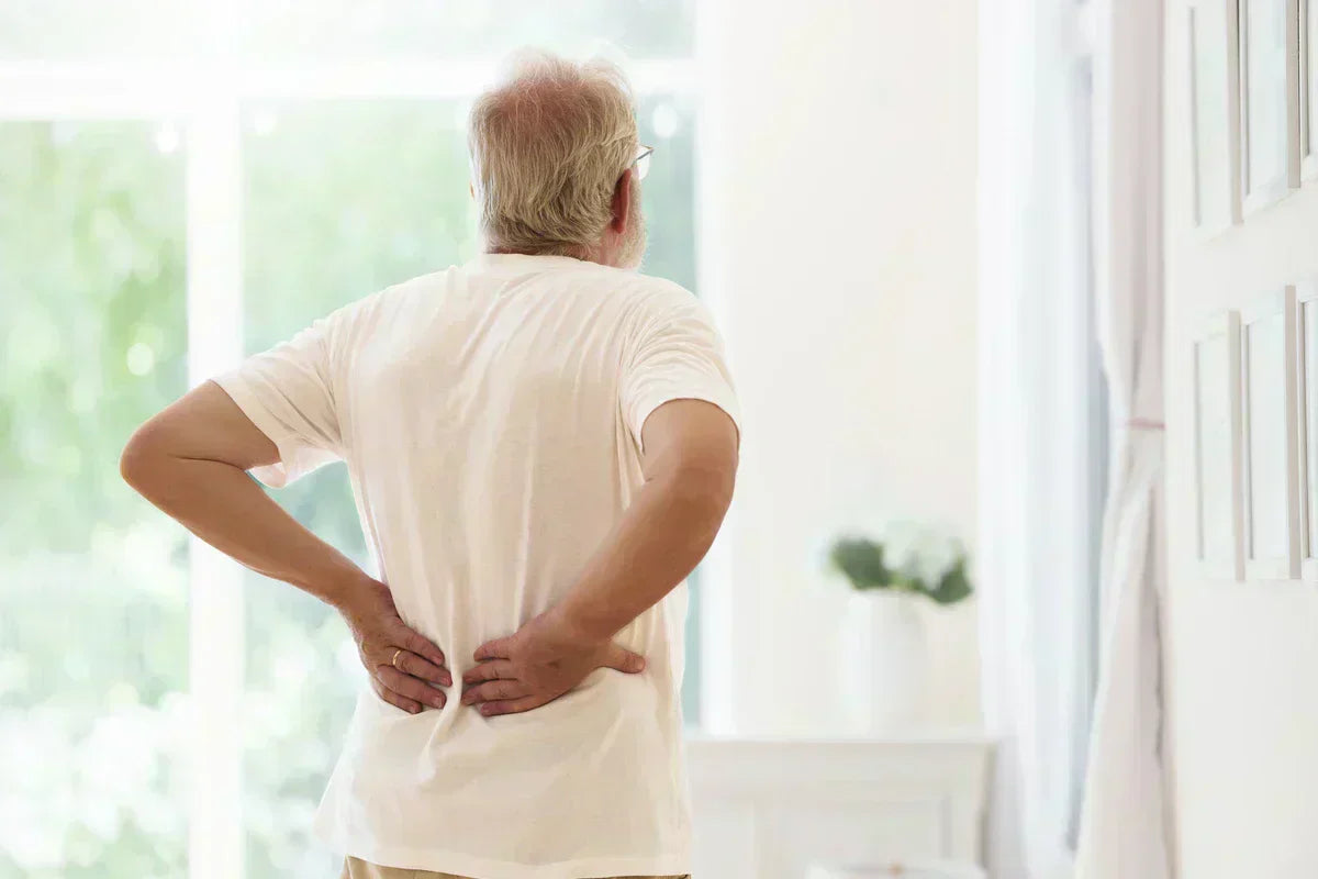 elderly man holding his painful back