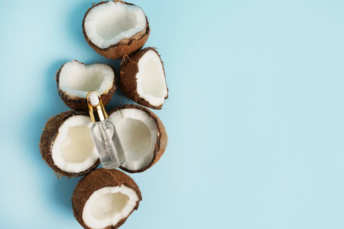 fresh coconuts with a bottle of mct oil for weight loss on top of them
