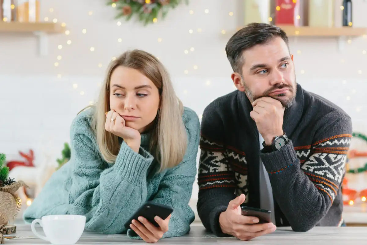 husband and wife leaning on the counter feeling exhausted from the holiday stress